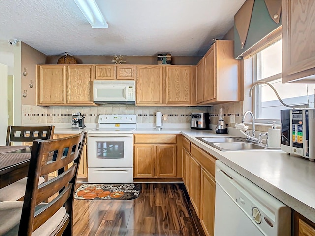 kitchen with a textured ceiling, tasteful backsplash, sink, white appliances, and dark hardwood / wood-style flooring