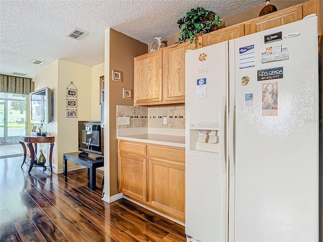 kitchen featuring backsplash, a textured ceiling, light brown cabinetry, white fridge with ice dispenser, and dark hardwood / wood-style floors