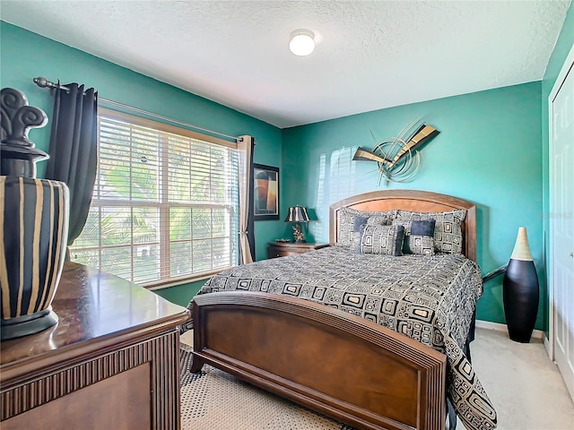 carpeted bedroom with a textured ceiling