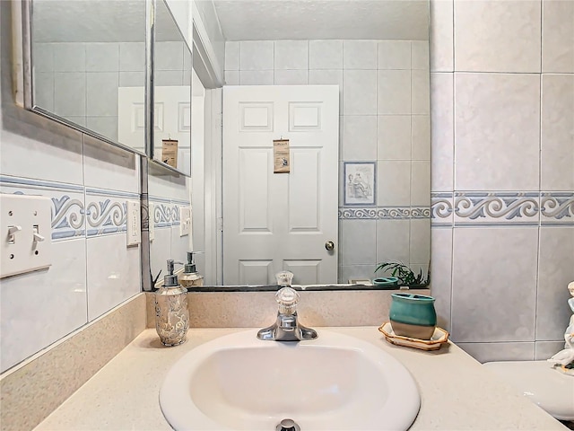 bathroom with tile walls and vanity