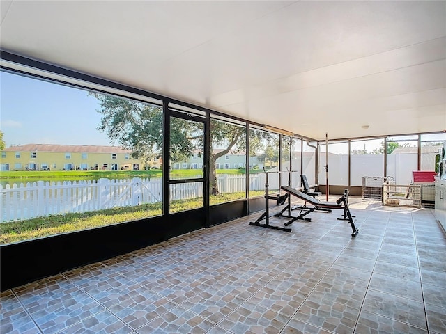 unfurnished sunroom with a water view