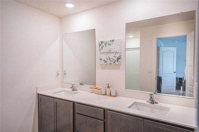 bathroom with a textured ceiling and vanity