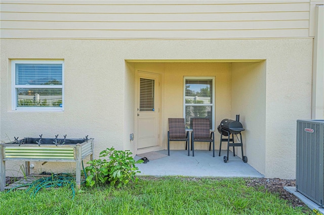 doorway to property featuring central AC unit and a patio area