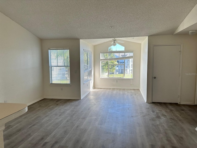 unfurnished living room featuring a textured ceiling, ceiling fan, lofted ceiling, and hardwood / wood-style flooring