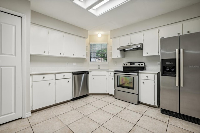 kitchen with white cabinets, sink, stainless steel appliances, and light tile patterned floors