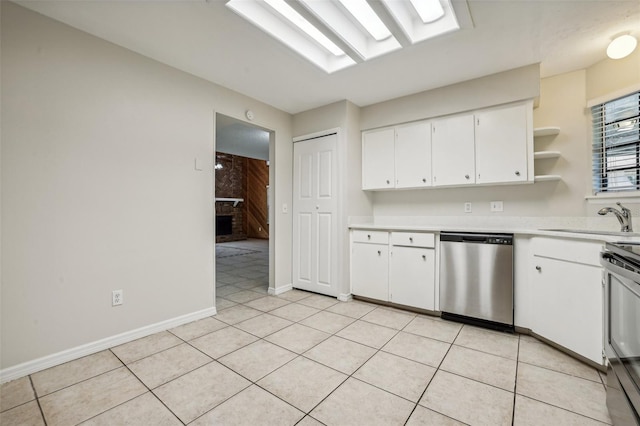 kitchen with white cabinetry, sink, light tile patterned floors, and stainless steel appliances