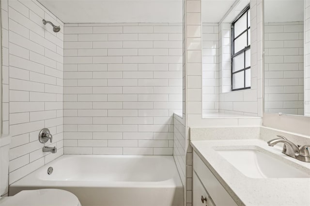 full bathroom featuring vanity, toilet, and tiled shower / bath