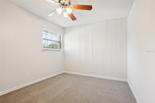 spare room with ceiling fan, a textured ceiling, and carpet flooring