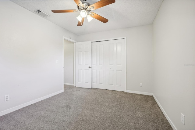 unfurnished bedroom featuring a closet, carpet, a textured ceiling, and ceiling fan