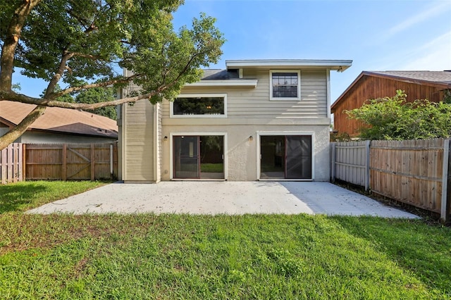 back of property featuring a yard and a patio area