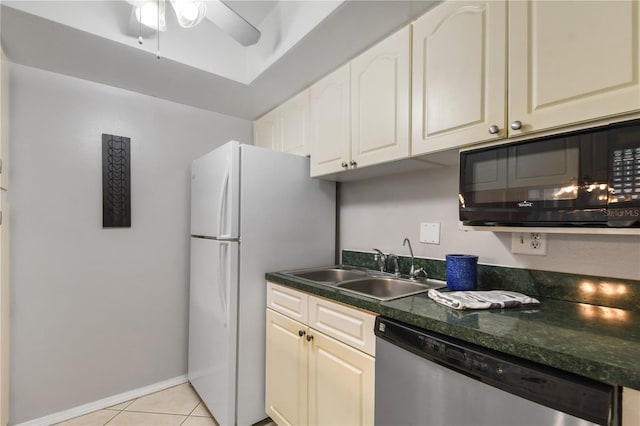 kitchen with white refrigerator, light tile patterned floors, ceiling fan, stainless steel dishwasher, and sink