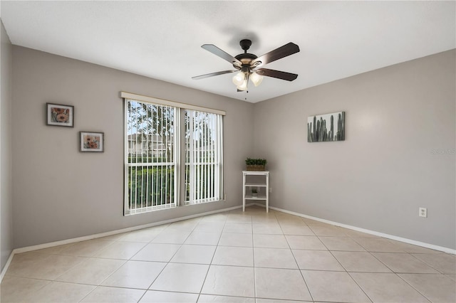 tiled spare room featuring ceiling fan