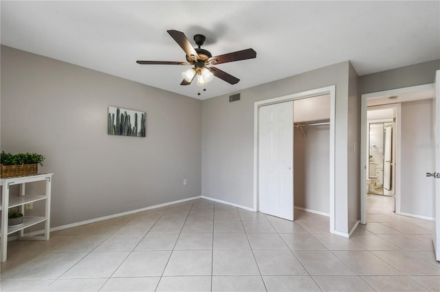 unfurnished bedroom featuring a closet, ceiling fan, and light tile patterned floors