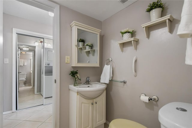 bathroom featuring tile patterned flooring, vanity, and toilet