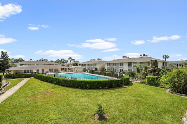 view of swimming pool featuring a lawn