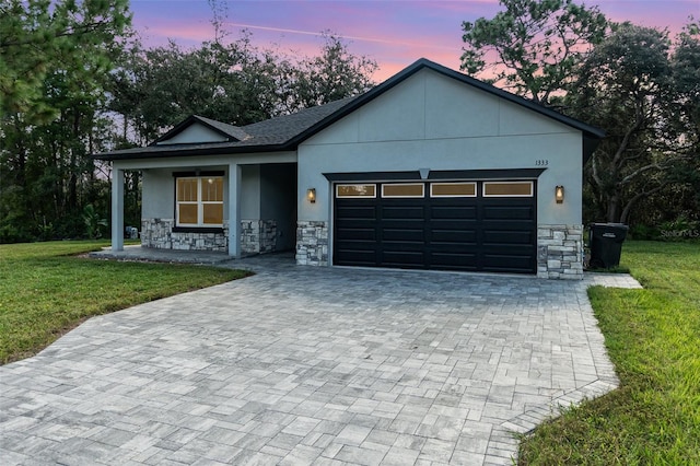 view of front facade with a lawn and a garage