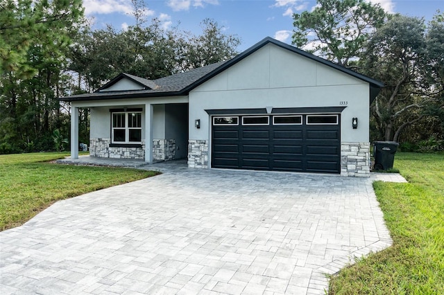 view of front of house with a front yard and a garage