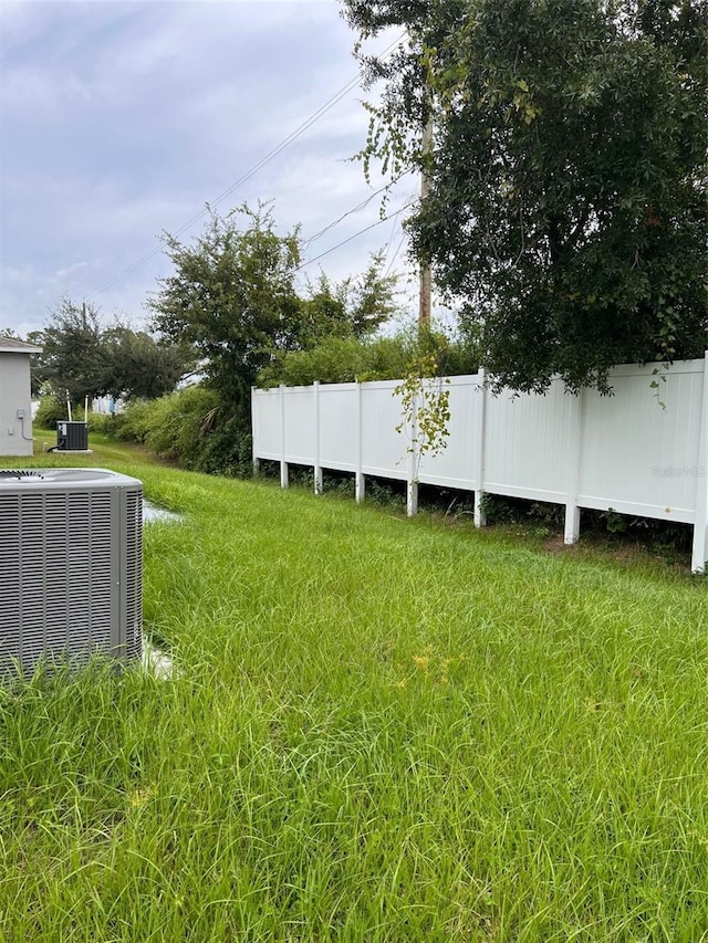 view of yard featuring central air condition unit