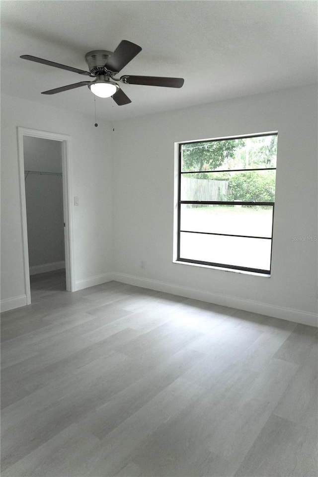 spare room with light hardwood / wood-style flooring and ceiling fan