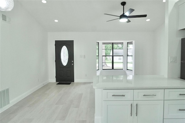 foyer featuring ceiling fan and light hardwood / wood-style flooring