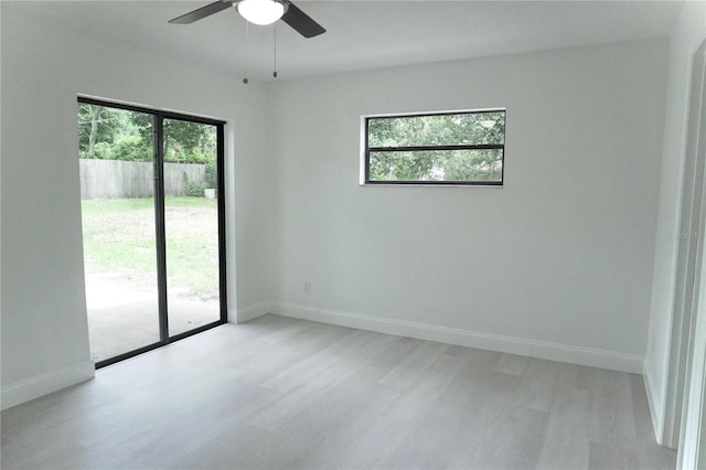 empty room featuring light hardwood / wood-style floors, ceiling fan, and plenty of natural light