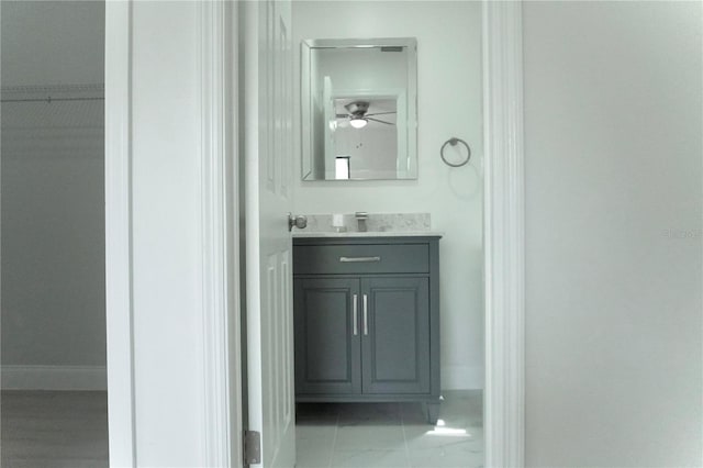 bathroom with ceiling fan and vanity