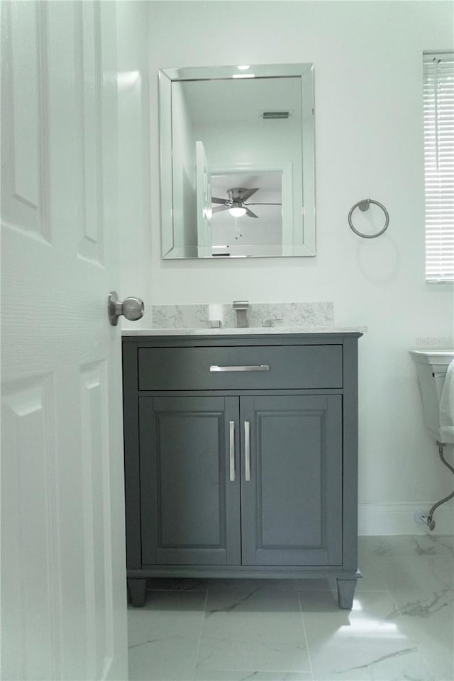 bathroom with ceiling fan and vanity