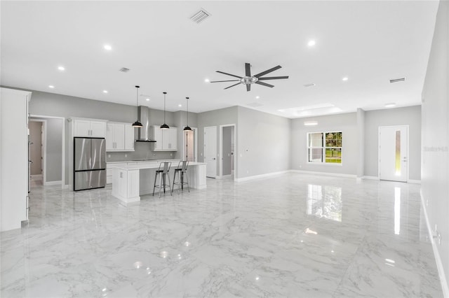 unfurnished living room with ceiling fan