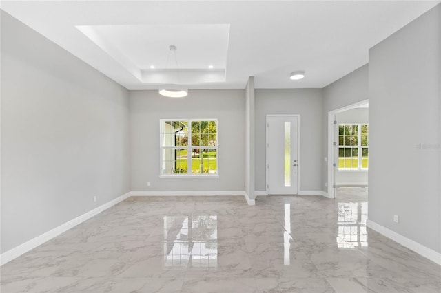 spare room featuring a tray ceiling