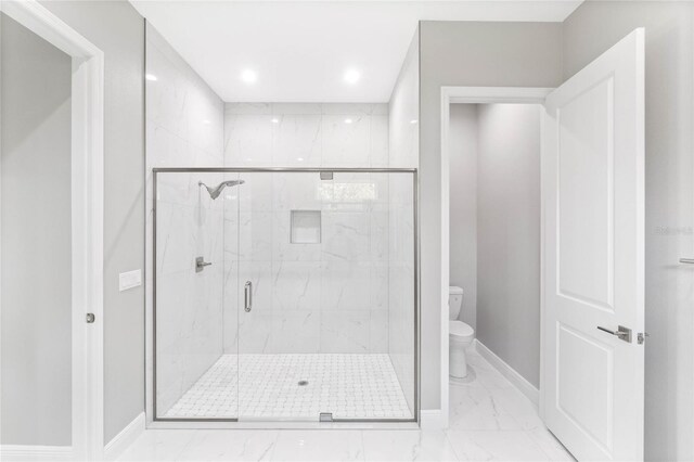 bathroom with an enclosed shower and toilet