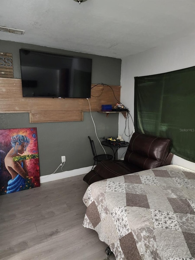 bedroom with wood-type flooring