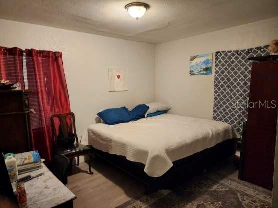 bedroom with wood-type flooring