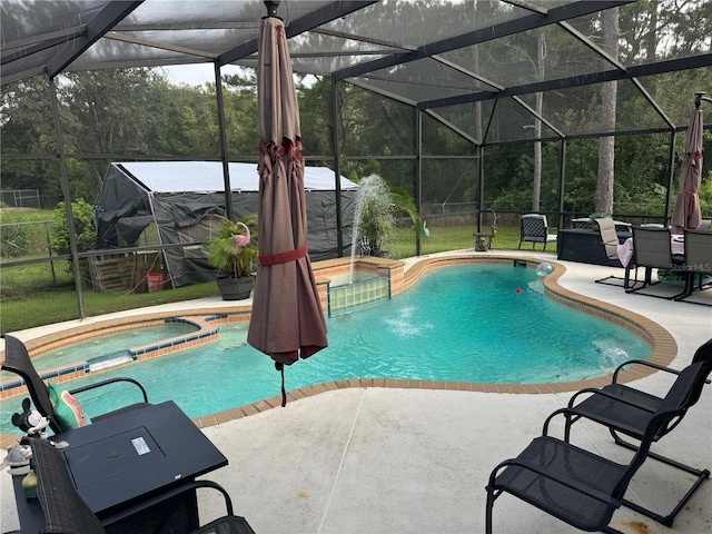 view of swimming pool featuring an in ground hot tub, glass enclosure, and a patio area