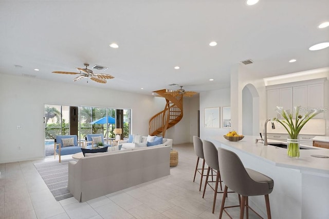 living room with sink and ceiling fan