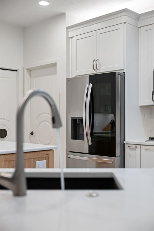 details with white cabinets, light countertops, stainless steel appliances, and recessed lighting