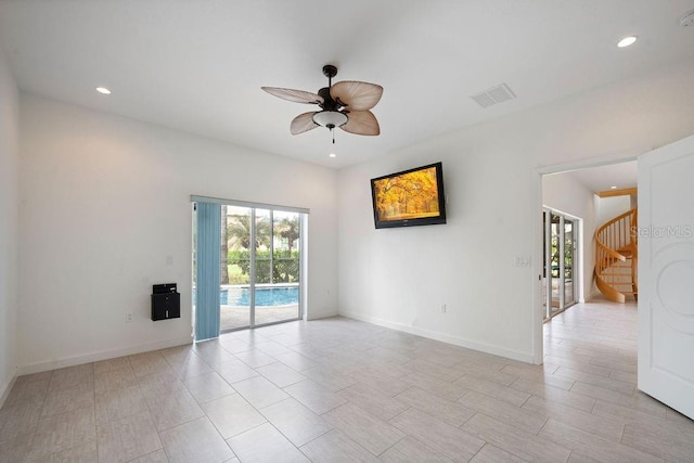 spare room featuring baseboards, stairs, recessed lighting, and a ceiling fan