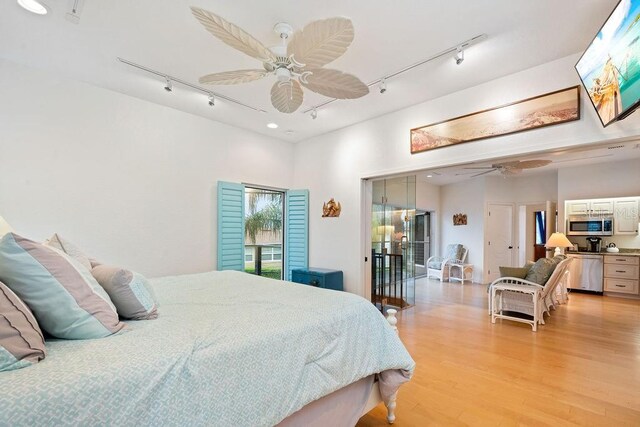 bedroom with ceiling fan, light wood-type flooring, and track lighting