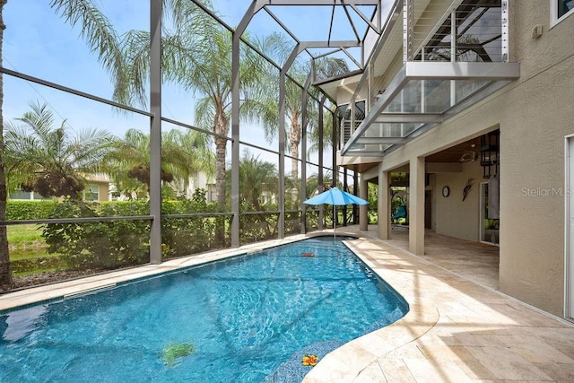 outdoor pool with a lanai and a patio area