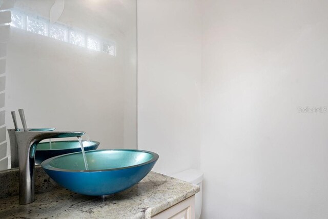 bathroom with vanity and toilet