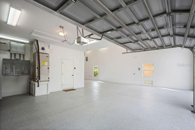 garage with a garage door opener and electric panel