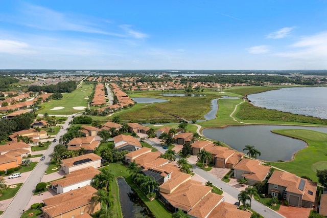 birds eye view of property featuring view of golf course, a residential view, and a water view