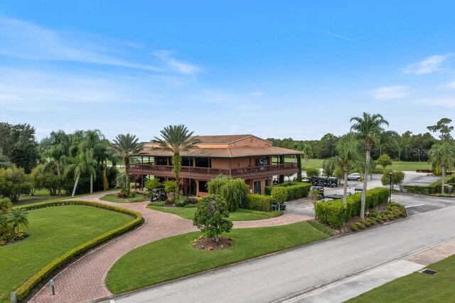 surrounding community with curved driveway and a yard