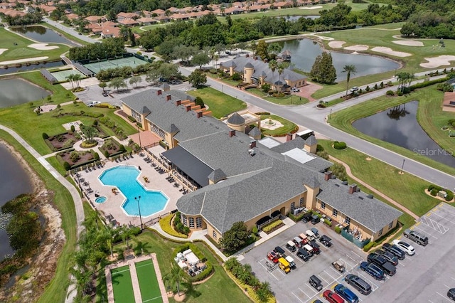 birds eye view of property with a water view, view of golf course, and a residential view