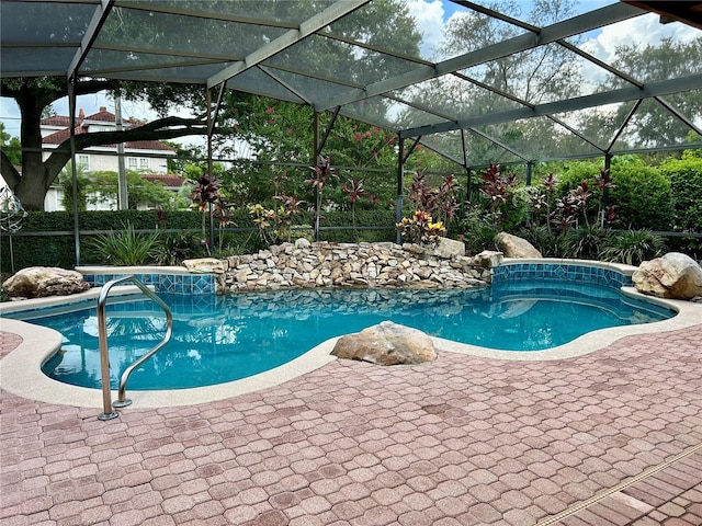 pool with a lanai and a patio area