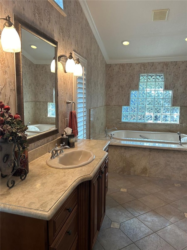 full bathroom with ornamental molding, visible vents, vanity, and a bath