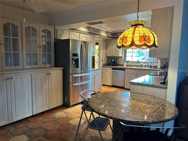 kitchen with glass insert cabinets, stainless steel appliances, backsplash, decorative light fixtures, and crown molding