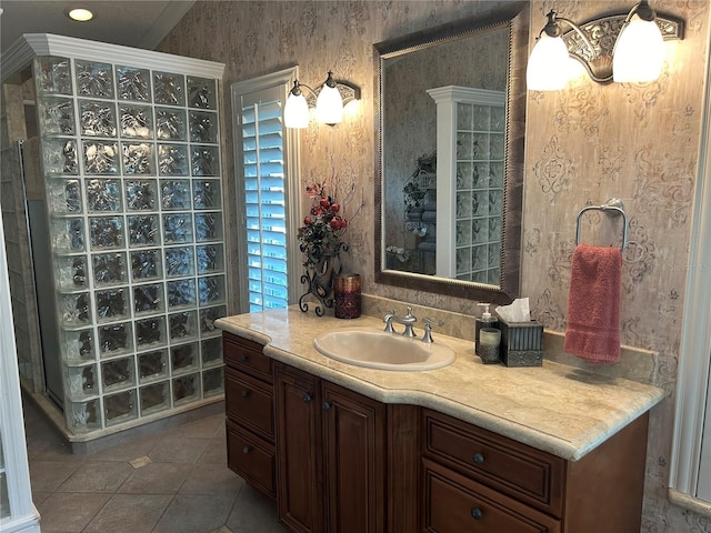 full bath featuring tile patterned flooring, vanity, and wallpapered walls