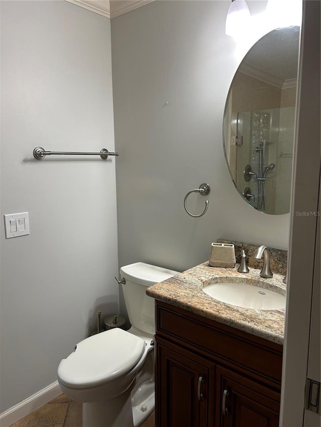 bathroom with toilet, vanity, baseboards, ornamental molding, and an enclosed shower