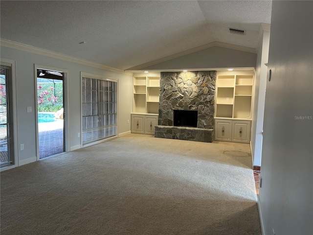 unfurnished living room featuring carpet, crown molding, vaulted ceiling, a stone fireplace, and a textured ceiling