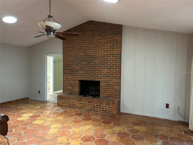 unfurnished living room featuring lofted ceiling, a fireplace, and ceiling fan